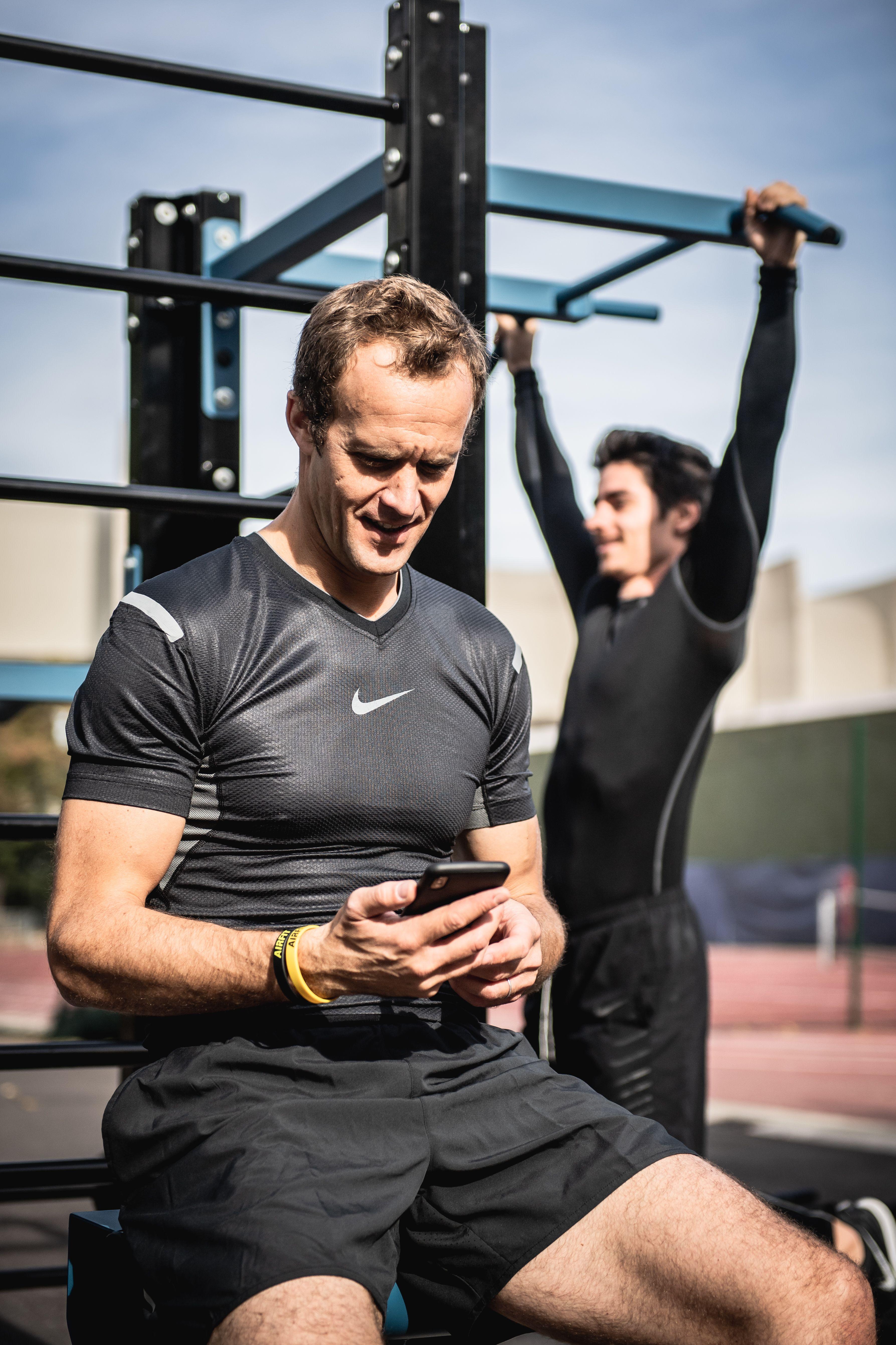 Gym owner reviewing CRM dashboard and automated messaging tools